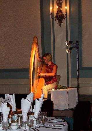 Alison performing amplified harp in ballroom of Victoria hotel
