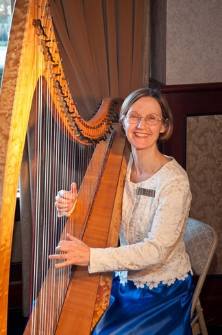 Picture of Alison playing Sandpiper Nova harp